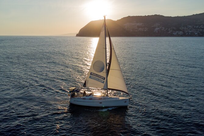 Sailing at sunset along the cliffs of Maro-Compartida - Music, skipper energy, and the feeling of ease