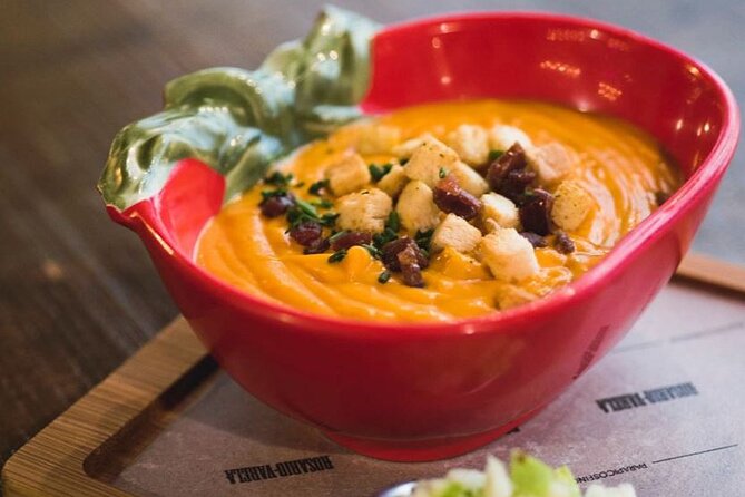 The Granada Evening Tapas Crawl by Food Lover Tour - Mid-crawl flavors: cold tomato soup, fried aubergines, and cured favorites